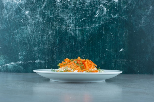 Chopped cabbage and carrots on white plate