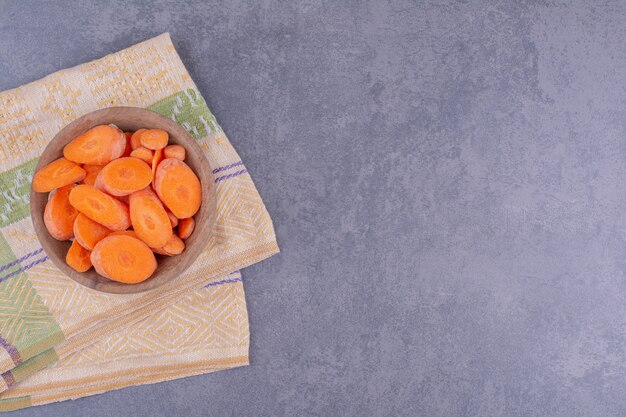 Chopped carrot slices in a wooden cup