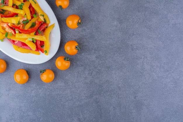 Chopped color bell pepper salad with cherry tomatoes