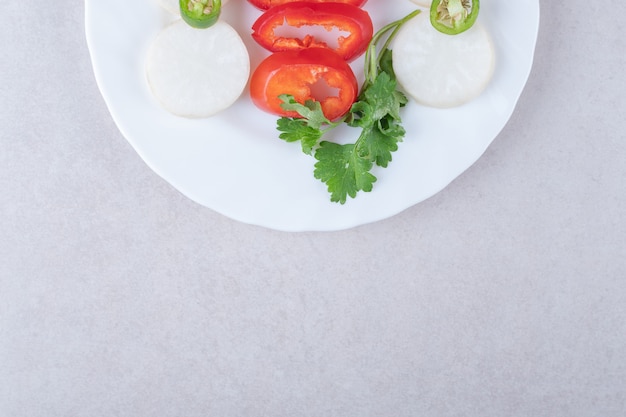 Chopped parsley and pepper on plate , on the marble.