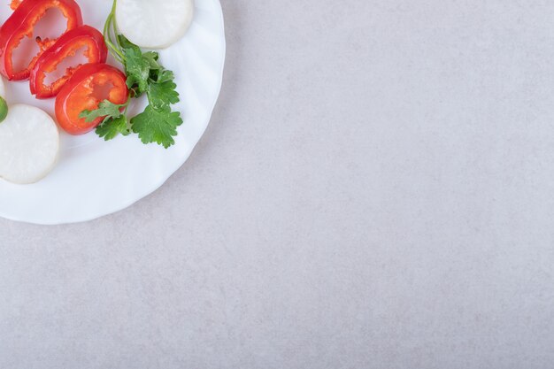 Chopped parsley and pepper on plate , on the marble.