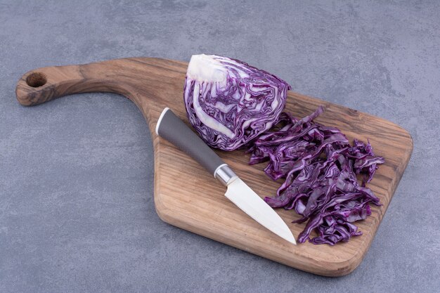 Chopped purple cabbage on a wooden platter.