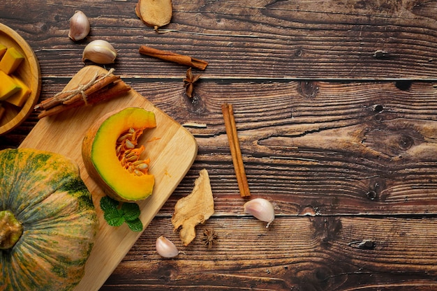 Chopped raw pumpkin put on wooden cutting board