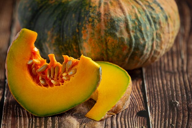 Chopped raw pumpkin put on wooden floor