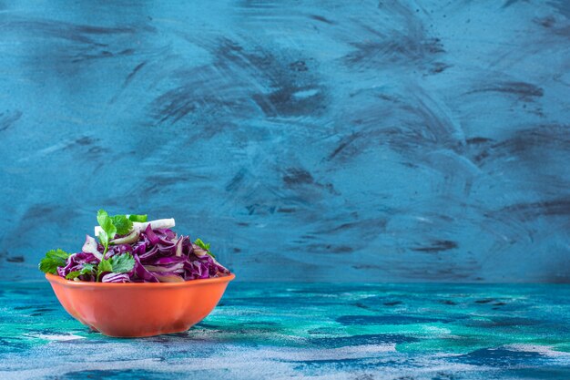 Chopped red cabbage, parsley and radish in a bowl 