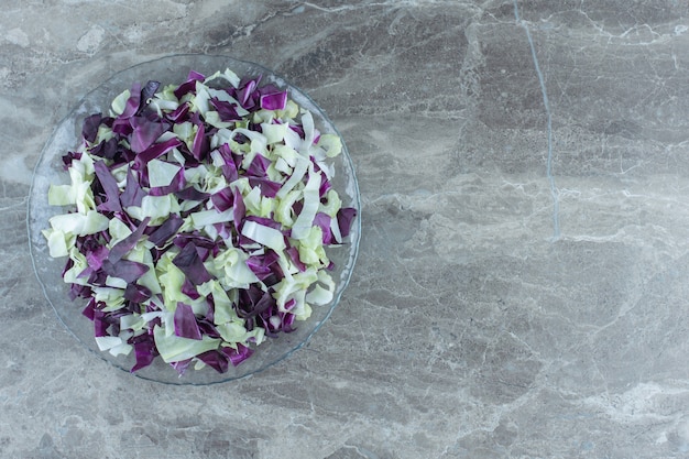 Free photo chopped vegetable in the glass bowl , on the marble table.