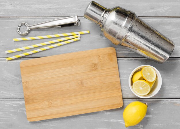 Chopping board with lemons and shaker