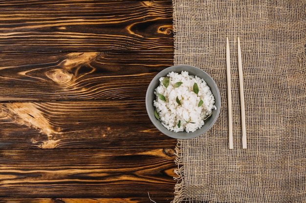 Chopsticks and linen cloth near rice