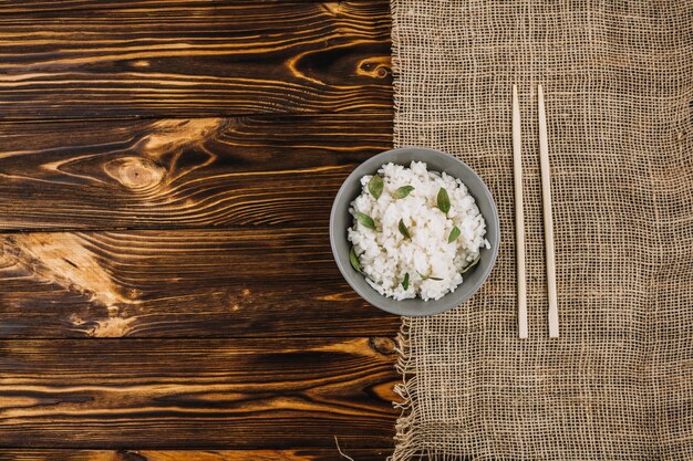 Chopsticks and linen cloth near rice