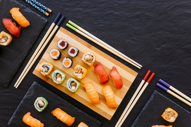 Chopsticks near sushi on boards