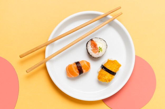 Chopsticks on plate with sushi