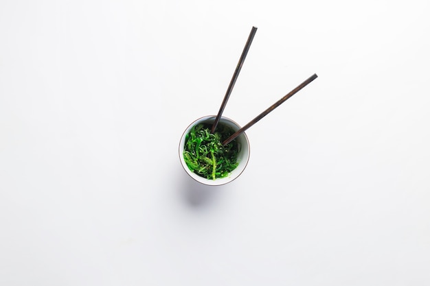 Chopsticks in seaweed salad