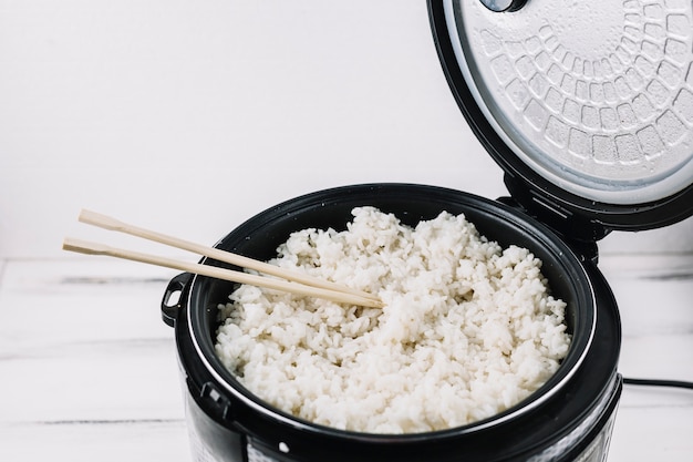 Chopsticks in steamer with rice