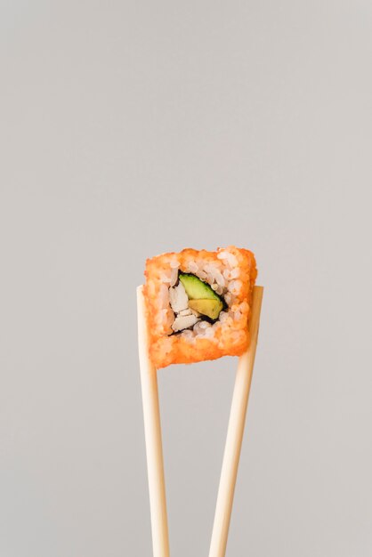 Chopsticks with sushi roll