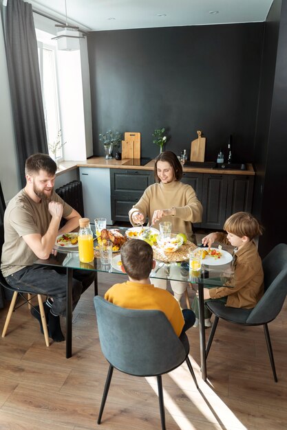 Christian family eating together full shot