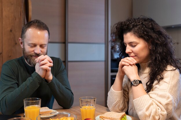 Christian family praying together