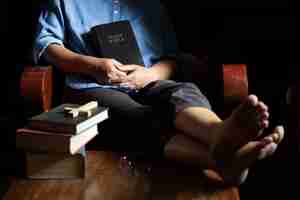 Free photo a christian woman sat on a wooden chair