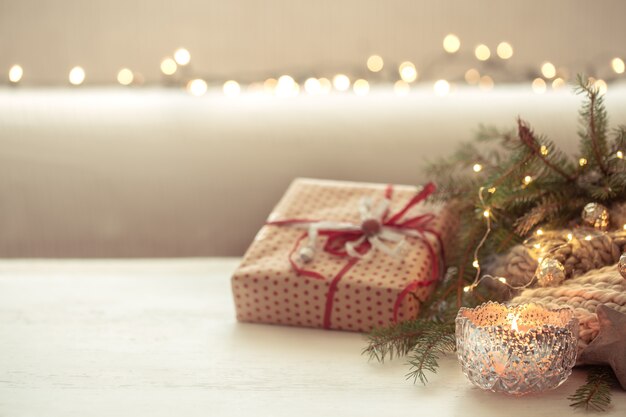 Christmas background with burning candles in the foreground. The concept of winter cozy and warmth.