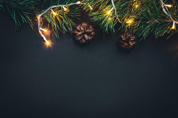 Christmas background with Christmas tree branches and garland flat lay