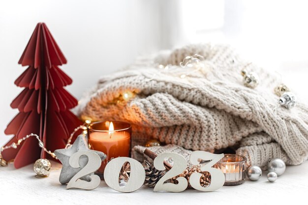 Christmas background with decorative numbers 2023 and cozy details