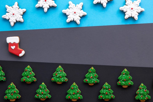 Christmas background with festive gingerbread covered with icing flat lay