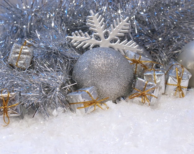 Christmas background with gifts and baubles nestled in snow