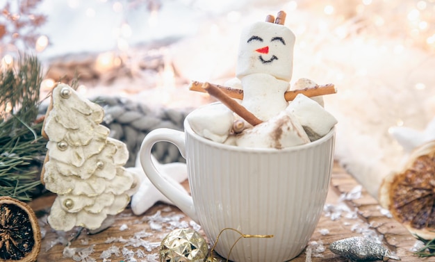 Free photo christmas background with marshmallow snowman in a cup
