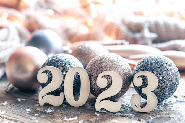 Christmas background with numbers 2023 and balls for the Christmas tree