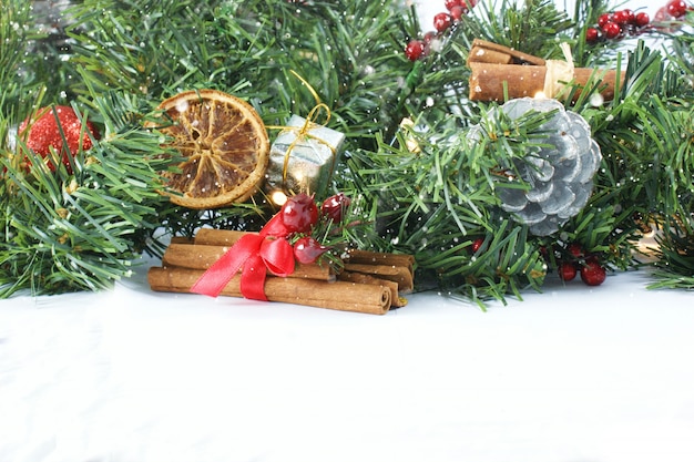 Christmas background with wreath, fir tree and cinnamon