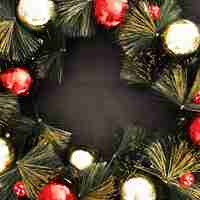 Free photo christmas ball on black textured background