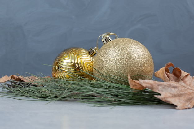 Christmas balls and dried leaves on gray table. High quality photo