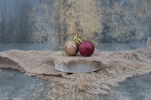 Christmas balls on marble table with burlap. High quality photo