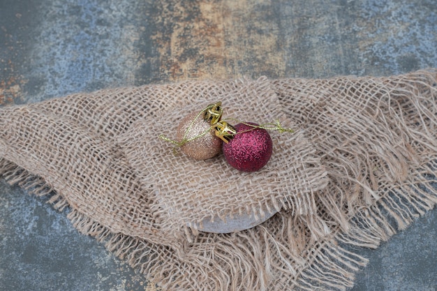 Christmas balls marble table with burlap. High quality photo