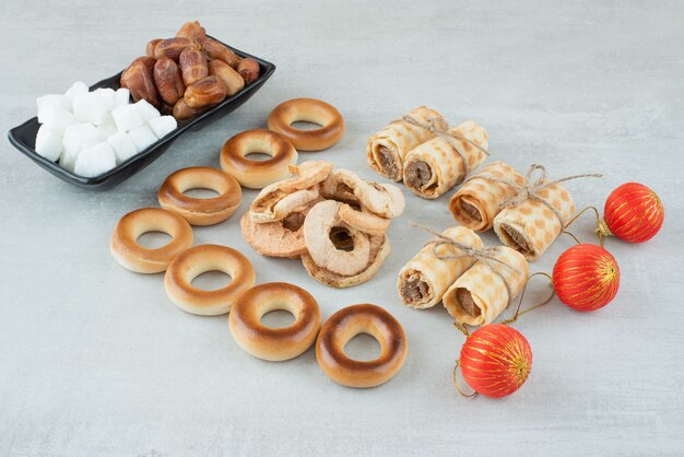 Christmas balls with waffles and sweet round cookies on white background. High quality photo