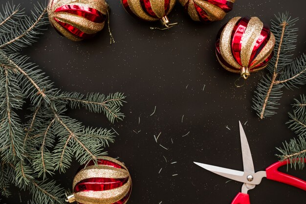 Christmas baubles near fir branches 