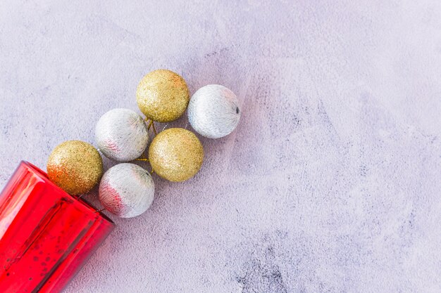 Christmas baubles near red glass