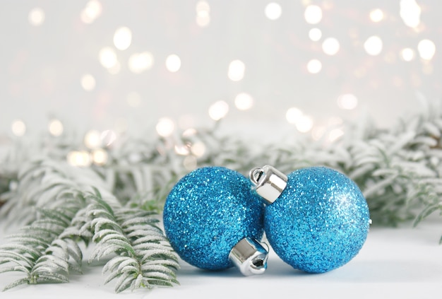 Christmas baubles with snowy fir tree branches