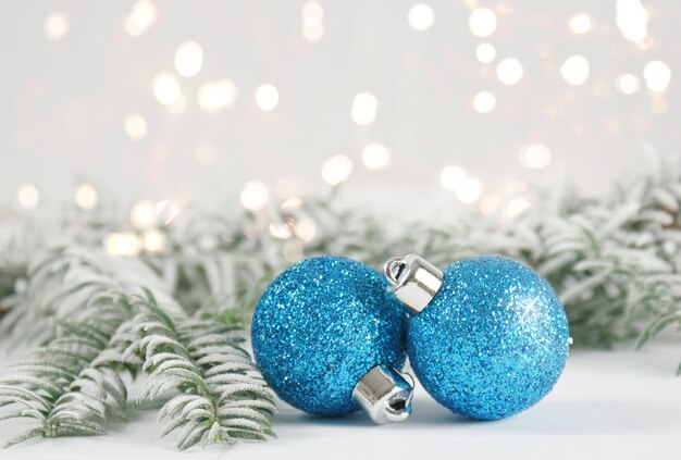 Christmas baubles with snowy fir tree branches