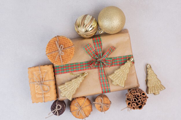 Christmas box with cookies, waffles and cinnamon sticks in rope 