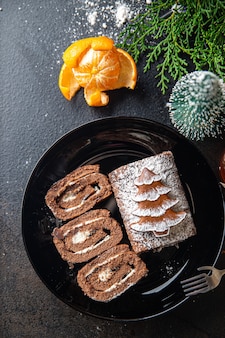 Christmas cake roll chocolate white cream new year meal snack on the table copy space food