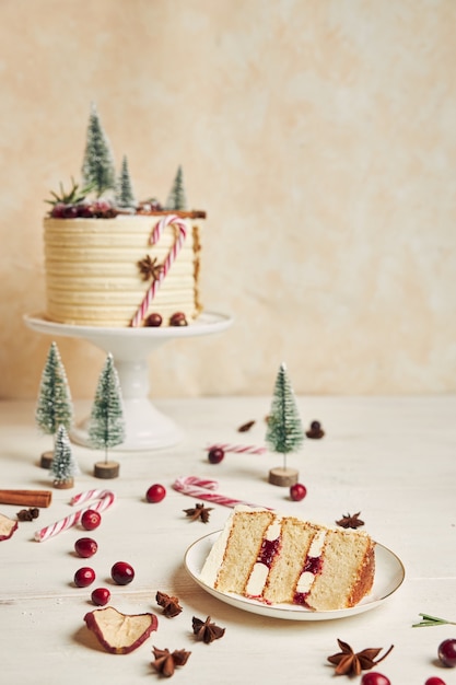 Christmas cake with decorations and a piece of cake on a plate