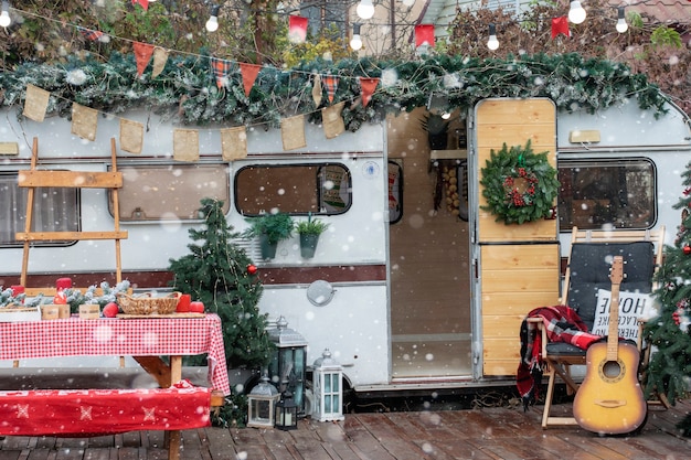 Christmas camping. the trailer is decorated with christmas decor.
