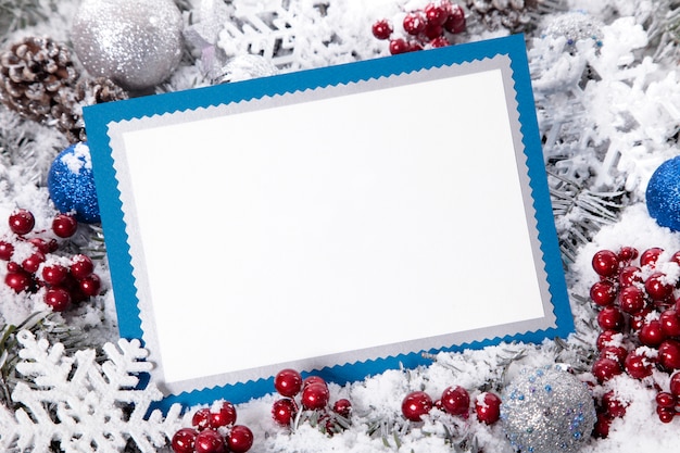 Christmas card with blue frame and red berries