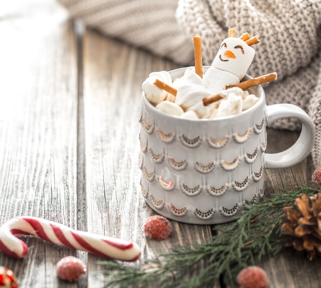 Christmas cocoa concept with marshmallows on a wooden background in a cozy festive atmosphere