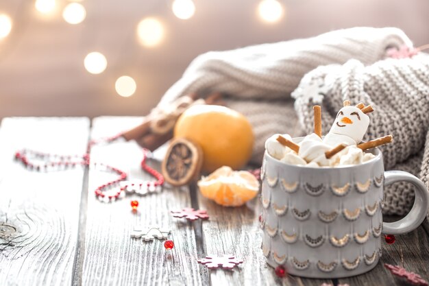 Christmas cocoa concept with marshmallows on a wooden background in a cozy festive atmosphere