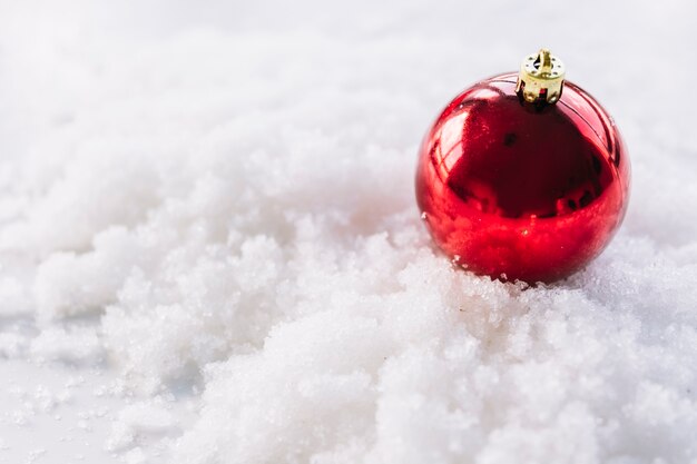 Christmas composition of bauble on snow