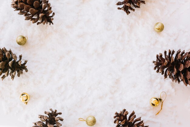 Christmas composition of cones on snow