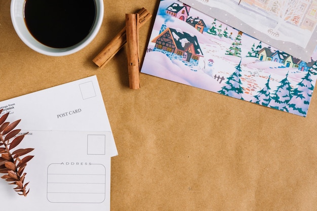 Christmas composition of cup coffee with postcards