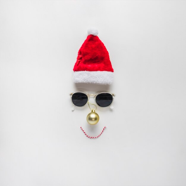 Christmas composition of face from Santa hat and sunglasses