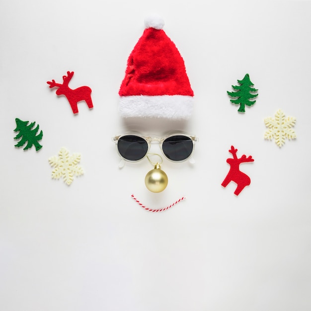 Christmas composition of face made from hat and sunglasses
